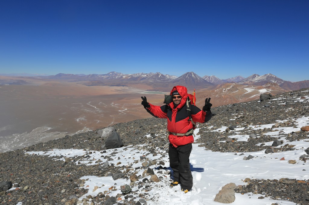 Feeling good on the way down! Behind my the Laguna Lejia we saw before sunrise. We'll spend some time on its shores shortly.  The awesome La Sportiva boots were a present from Susan, they work beautifully and are warm and comfy. Definitely suitable for this kind of high altitude alpinism. You notice I'm dressed like Michelin Man, and there's a reason for that: While thinner clothing would have been warm enough as well, when going to these extreme places, survival considerations are paramount: you dress for when something bad happens to you and you won't be able to move. Picture yourself sitting still in a stiff breeze at -10C. That's what you need to dress for. Because Christof didn't have this kind of clothing, I carried my -20C rated sleeping bag for safety.